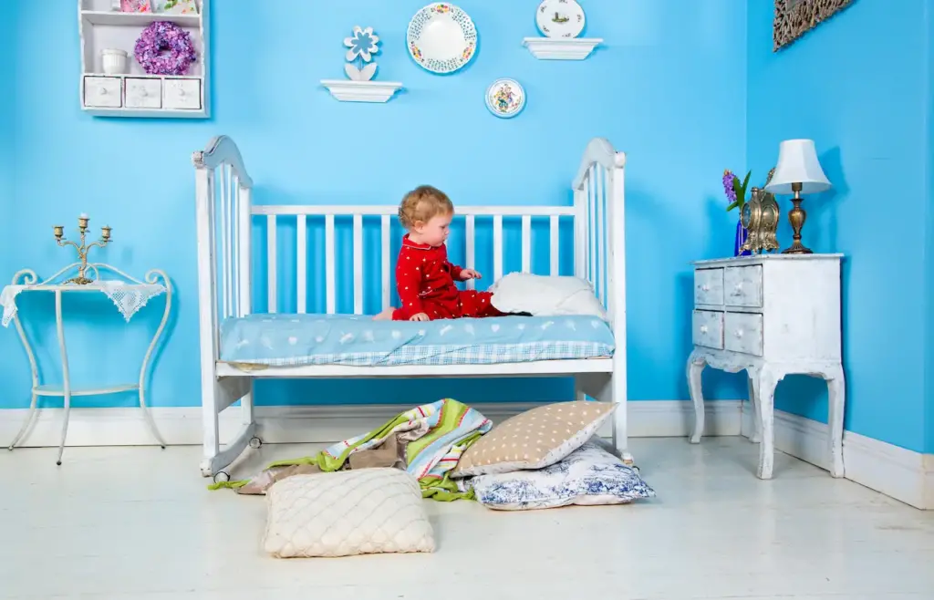 A Baby Playing on the Bed Alone